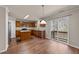 Bright kitchen with wood cabinets, granite counters and center island opening to dining area at 264 Farrington Dr, Clayton, NC 27520