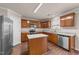 Bright kitchen with wood cabinets, stainless steel appliances and a granite-topped center island at 264 Farrington Dr, Clayton, NC 27520