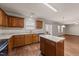 Bright kitchen with wood cabinets, granite counters and center island opening to living area at 264 Farrington Dr, Clayton, NC 27520