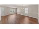 Spacious living room featuring hardwood floors, modern lighting, and neutral wall paint at 264 Farrington Dr, Clayton, NC 27520