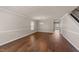 Spacious living room featuring hardwood floors, modern lighting, and neutral wall paint at 264 Farrington Dr, Clayton, NC 27520