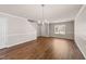 Spacious living room featuring hardwood floors, modern lighting, and neutral wall paint at 264 Farrington Dr, Clayton, NC 27520