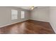 Spacious living room featuring hardwood floors and natural light from two windows at 264 Farrington Dr, Clayton, NC 27520