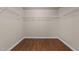 Spacious walk-in closet with modern rack system and wood-look flooring at 264 Farrington Dr, Clayton, NC 27520