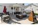 Spacious back patio featuring outdoor seating, a modern fireplace, barbecue grill, and outdoor dining at 277 Martins Mill Ct, Wendell, NC 27591