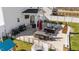 Backyard with comfortable patio seating, outdoor kitchen, play space, and privacy fence at 277 Martins Mill Ct, Wendell, NC 27591