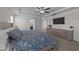 Spacious bedroom with a tray ceiling, a mounted television, and a view into the bathroom at 277 Martins Mill Ct, Wendell, NC 27591