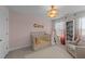 Bedroom featuring a crib, bookshelf, and a neutral color palette at 277 Martins Mill Ct, Wendell, NC 27591
