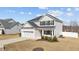 Beautiful two-story home with manicured lawn, a two-car garage, and traditional design elements at 277 Martins Mill Ct, Wendell, NC 27591