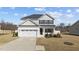 Exterior elevation of a two-story home showcasing a well-manicured lawn and a two-car garage at 277 Martins Mill Ct, Wendell, NC 27591
