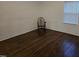 Bedroom with hardwood floors, lots of natural light, and a simple wooden chair at 301 Wilson St, Franklinton, NC 27525