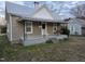 Charming single-Gathering home with a covered front porch and swing, steps, and manicured lawn at 301 Wilson St, Franklinton, NC 27525