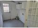 Clean laundry room with white cabinets, grey floor, and exterior door to the outside at 301 Wilson St, Franklinton, NC 27525