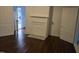Spacious living room with hardwood flooring, white walls, two entryways, and non-operable fireplace at 301 Wilson St, Franklinton, NC 27525