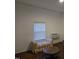 Inviting living room with a window, window AC unit, wooden floors, and a comfortable bench seat at 301 Wilson St, Franklinton, NC 27525