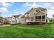 Expansive backyard with a view of neighboring homes and well-maintained lawn at 306 Village Orchard Rd, Cary, NC 27519