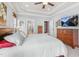 Main bedroom suite with a tray ceiling, hardwood floors, and an en-suite bathroom with great natural light at 306 Village Orchard Rd, Cary, NC 27519