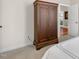 Spacious bedroom featuring a large wardrobe, neutral carpet, and an open doorway to another room at 306 Village Orchard Rd, Cary, NC 27519