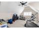 Versatile bonus room with gym equipment, TV, and ceiling fan at 306 Village Orchard Rd, Cary, NC 27519