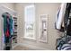 Walk-in closet featuring shelving, window, lots of hanging space, and a mirror at 306 Village Orchard Rd, Cary, NC 27519