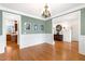 Formal dining room featuring hardwood floors and elegant wainscoting at 306 Village Orchard Rd, Cary, NC 27519