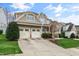 Charming home with a two-car garage, well-manicured lawn, and inviting curb appeal at 306 Village Orchard Rd, Cary, NC 27519