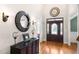 Inviting foyer with hardwood floors and a decorative mirror at 306 Village Orchard Rd, Cary, NC 27519