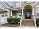 Inviting front porch with stone steps and elegant columns at 306 Village Orchard Rd, Cary, NC 27519