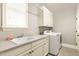 Bright laundry room features modern washer and dryer, sink and ample cabinet space at 306 Village Orchard Rd, Cary, NC 27519