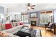 Bright and airy living room with a cozy fireplace, large windows, hardwood floors, and comfortable seating at 306 Village Orchard Rd, Cary, NC 27519