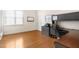 Spacious home office featuring hardwood floors, natural light, and ample desk space for productivity at 306 Village Orchard Rd, Cary, NC 27519
