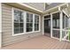 View of a covered porch with a screened-in entrance and large windows offering natural light and a view of the outdoors at 306 Village Orchard Rd, Cary, NC 27519