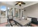 Covered, screened porch offers outdoor dining space with peaceful views at 306 Village Orchard Rd, Cary, NC 27519
