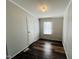 Bedroom featuring light-colored walls, hardwood floors, and a window for natural light at 3211 Kipling Rd, Fuquay Varina, NC 27526