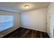 Bright bedroom with hardwood floors, a window, and a built-in ceiling light at 3211 Kipling Rd, Fuquay Varina, NC 27526
