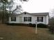 Inviting home featuring mature landscaping, a birdhouse and a welcoming entryway at 3211 Kipling Rd, Fuquay Varina, NC 27526