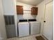 Functional laundry room with washer, dryer, and extra cabinet space at 3211 Kipling Rd, Fuquay Varina, NC 27526