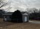 View of detached block building with a garage door and entry door at 3211 Kipling Rd, Fuquay Varina, NC 27526