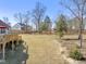 Home exterior showcasing a large backyard with a wooden deck and outdoor grilling station, great for outdoor activities at 33 Song Breeze Cir, Angier, NC 27501