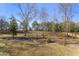 Large backyard featuring an expansive lawn, complemented by a classic wooden fence for privacy and definition at 33 Song Breeze Cir, Angier, NC 27501