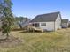 Home exterior featuring a well-maintained backyard, wooden deck with outdoor kitchen and screened-in porch at 33 Song Breeze Cir, Angier, NC 27501