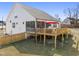 Home exterior showcasing a spacious backyard with wooden deck and outdoor grilling station, and screened-in porch at 33 Song Breeze Cir, Angier, NC 27501