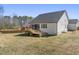 Home exterior showcasing a spacious backyard and wooden deck with outdoor grilling station and screened-in porch at 33 Song Breeze Cir, Angier, NC 27501