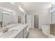 Bright bathroom with double sinks, quartz countertops, and separate tub and shower at 33 Song Breeze Cir, Angier, NC 27501