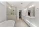Modern bathroom with a soaking tub, glass shower, and double vanity with ample counter space at 33 Song Breeze Cir, Angier, NC 27501