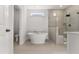 Luxurious bathroom with a soaking tub, glass-enclosed shower, and modern fixtures at 33 Song Breeze Cir, Angier, NC 27501