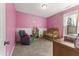 Cozy Bedroom with pink walls, crib, and comfortable chair at 33 Song Breeze Cir, Angier, NC 27501