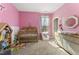 Bright Bedroom with a crib, dresser, and pink walls at 33 Song Breeze Cir, Angier, NC 27501