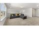 Bright bonus room featuring plush carpeting, recessed lighting, and comfortable couch at 33 Song Breeze Cir, Angier, NC 27501