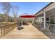 Expansive wooden deck with red umbrella, outdoor kitchen and grilling space plus screened-in porch perfect for entertaining at 33 Song Breeze Cir, Angier, NC 27501